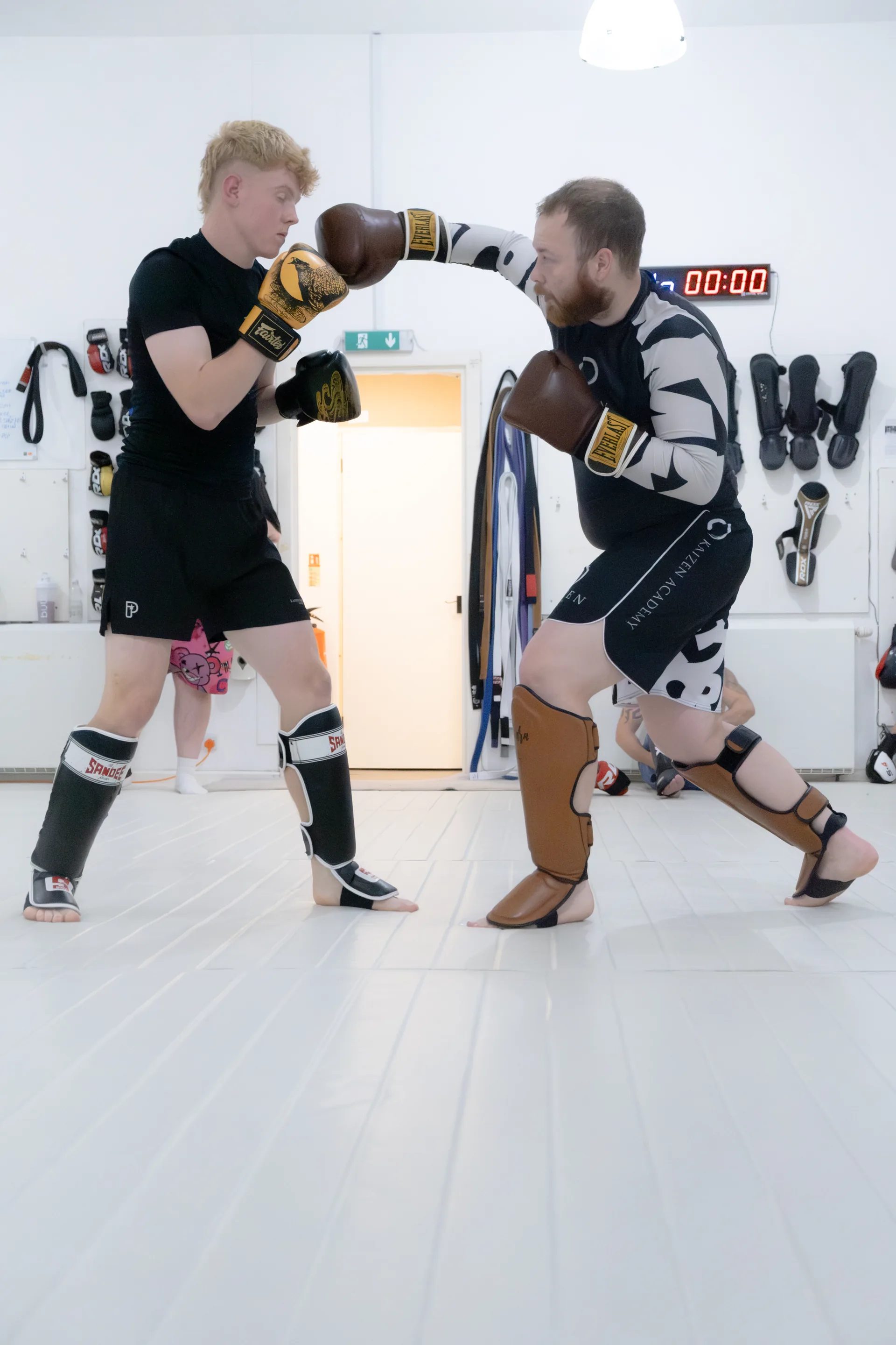 Two kickboxing partners practising a controlled boxing drill