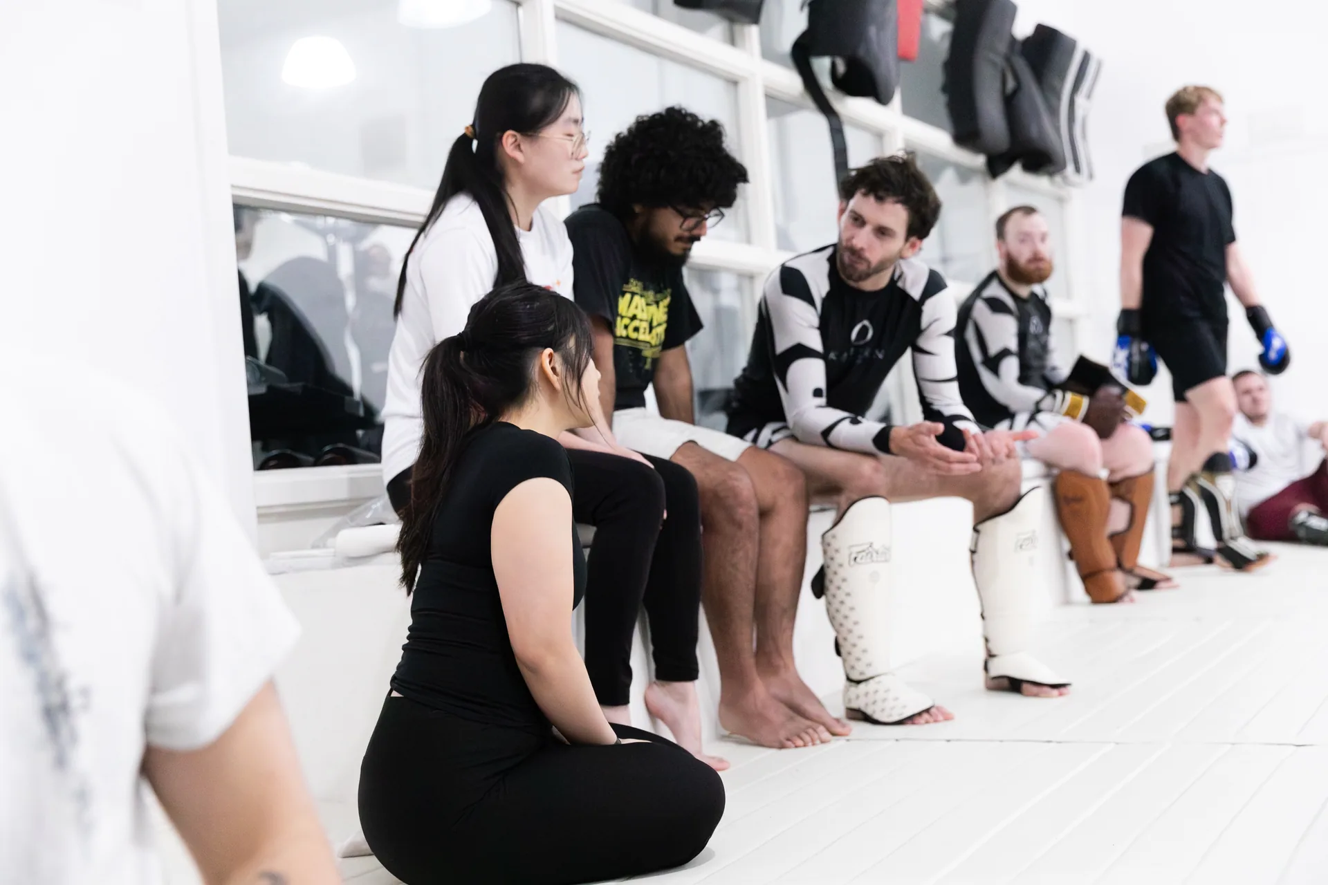 A Kaizen coach talking with members between training rounds